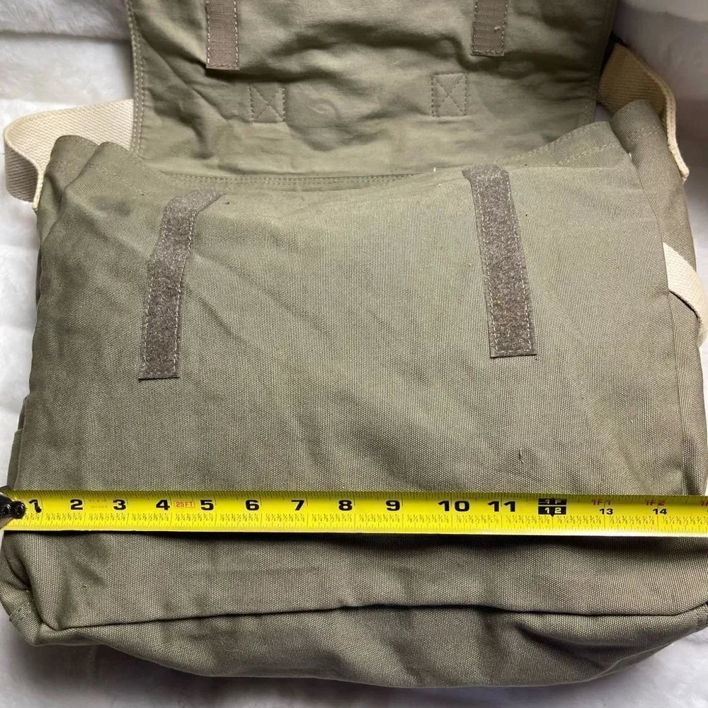 Lucky Brand large canvas olive green messenger bag with adjustable beige strap.